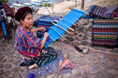 Guatemalan indigenous woman weaving traditional crafts on the lake Atitlan